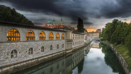 Mystical Castle Reflected in Slovenian River wallpaper