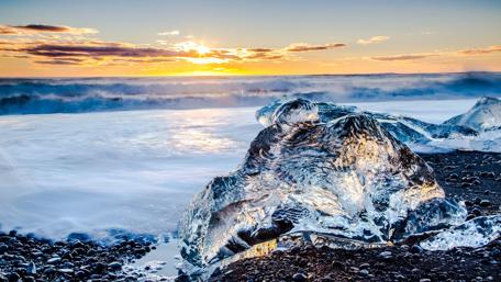 Icy Waves Beneath a Golden Sunset wallpaper