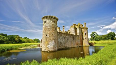 Majestic Lakeside Castle Under Blue Sky wallpaper