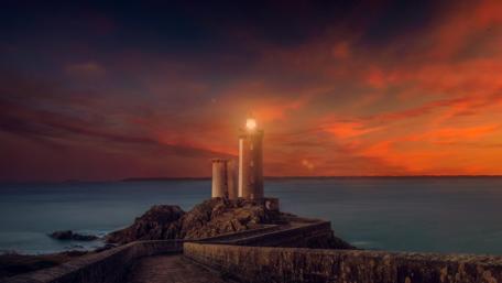 Majestic Lighthouse at Twilight Brightens the Sea wallpaper