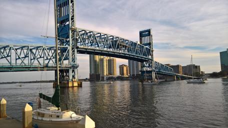 Vibrant Cityscape at Dusk with a Bridge and Waterway wallpaper