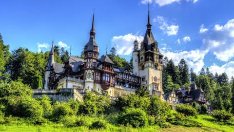 Majestic Peles Castle Amidst Verdant Greens wallpaper