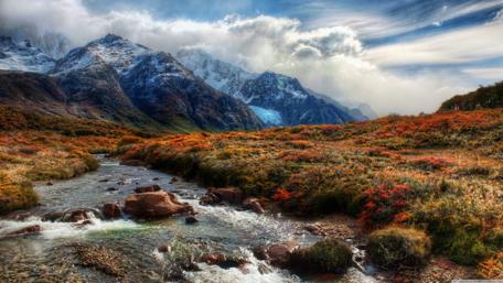 Majestic Mountain Stream in Autumn Splendor wallpaper