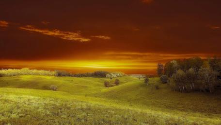 Breathtaking Sunset Over Rolling Green Hills wallpaper