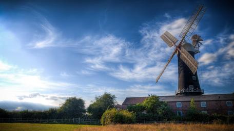 Peaceful Windmill Under a Blue Sky wallpaper