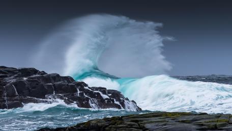 Stormy Waves Crashing Against Rocks wallpaper