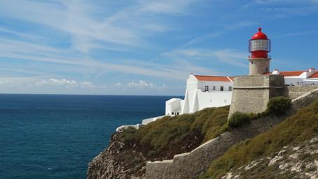 Coastal Lighthouse by the Sea in Bright Sunlight wallpaper