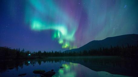 Dazzling Aurora Over Tranquil Lake Night Scene wallpaper