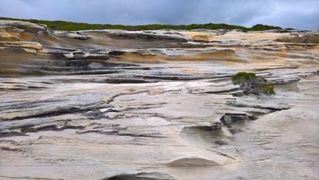 Stunning Rocky Terrain Under Cloudy Skies wallpaper