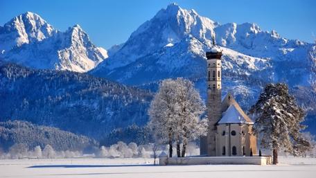 Snowy Church Serenity in Icy Mountain Landscape wallpaper