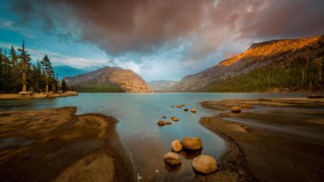 Tranquil Lake Under Dramatic Skies wallpaper