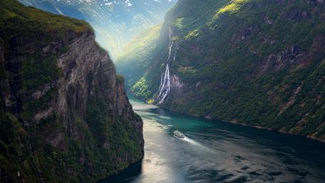 Majestic River Cutting Through Lush Cliffs wallpaper