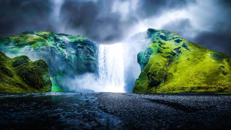 Majestic Waterfall Under Cloudy Sky wallpaper