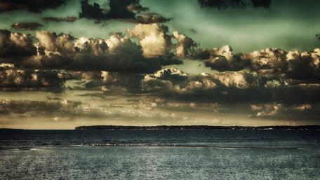 Majestic Clouds Over Tranquil Waters wallpaper