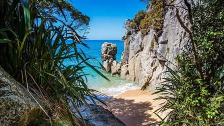 Breathtaking Seashore Escape Among Cliffs and Rocks wallpaper