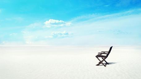 Serene Beach Chair Overlooking the Sea wallpaper