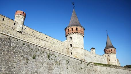 Majestic Fortress Under Clear Blue Sky wallpaper