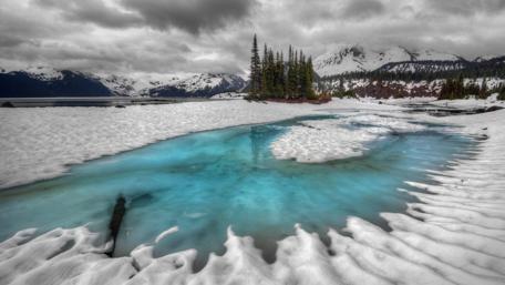 Majestic Snowy Landscape with Azure Water wallpaper