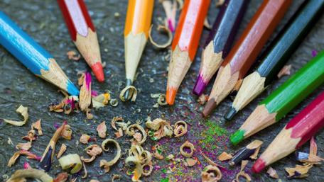 Vibrant Pencils and Colorful Shavings Create Artistic Harmony wallpaper