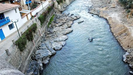 Serene River Flowing Through Urban Landscape wallpaper