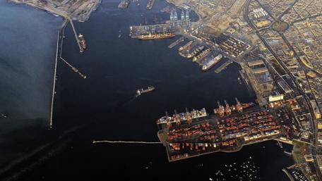 Urban Harbor Aerial View of Busy Port Facilities and Cityscape wallpaper
