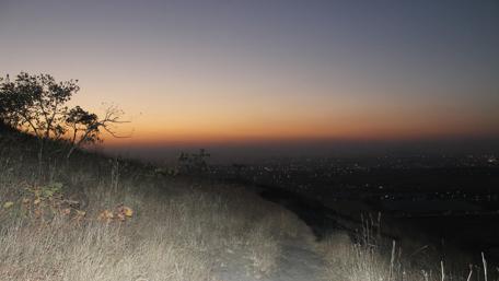 Serene Sunset Over a Distant Cityscape wallpaper