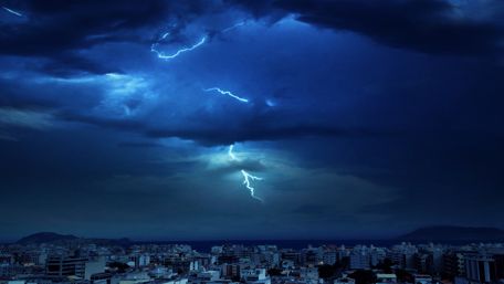 Electrifying Night Thunderstorm Over a Cityscape wallpaper