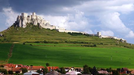Majestic Spis Castle Overlooking Lush Fields wallpaper