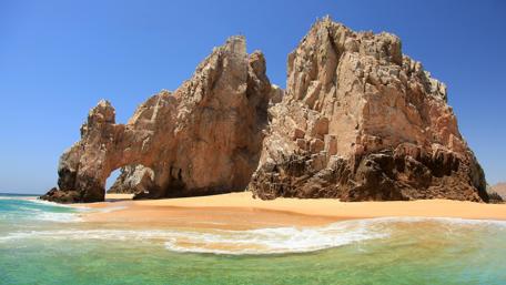 Secluded Rocky Seashore Arch in 4K wallpaper