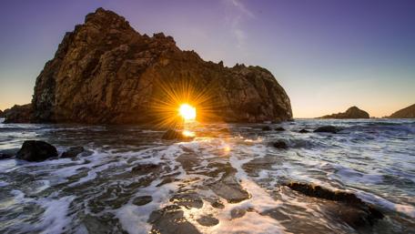 Golden Sunlight Through Rocky Archway at Dusk wallpaper