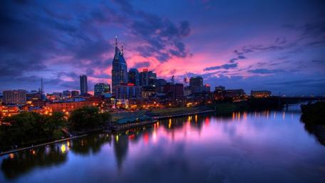 Purple Sunset Skies Over Cityscape wallpaper