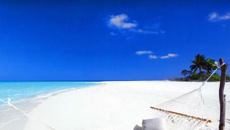 Tranquil Beach Escape Amidst Azure Waters wallpaper