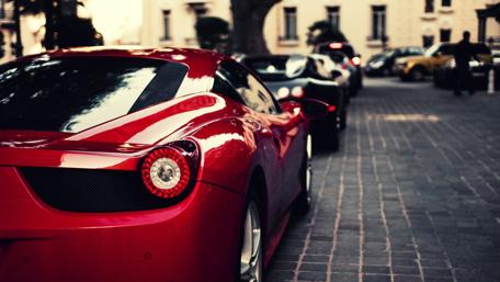 Vibrant Red Sports Car on a City Street wallpaper