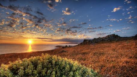 Breathtaking Sunset Over Coastal Landscape wallpaper