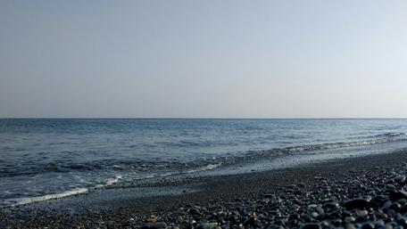 Calm Seascape with Smooth Pebbles and Clear Sky wallpaper