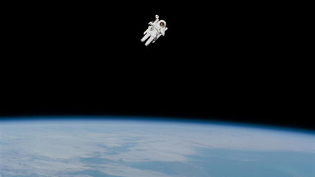 Astronaut Floating Above Earth in 4K Quality wallpaper