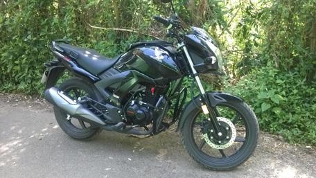 Sleek Black Motorcycle in Nature's Embrace wallpaper