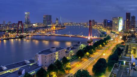 Cityscape at Dusk with Glowing Lights and Reflections wallpaper
