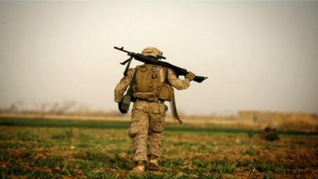 Soldier on Patrol in Barren Field wallpaper
