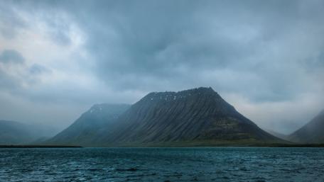 Majestic Mountain Under Cloudy Skies wallpaper