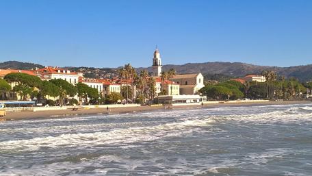 Serene Coastal Cityscape with Waves and Palm Trees wallpaper