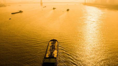 Golden Horizon with a Boat Sailing Smoothly wallpaper