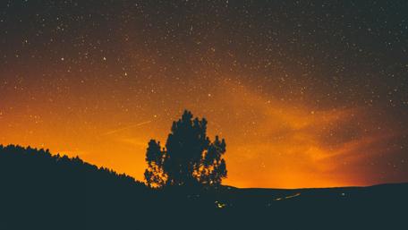 Starry Night Over Orange Horizon wallpaper