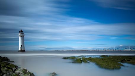Serene Lighthouse by the Tranquil Sea wallpaper