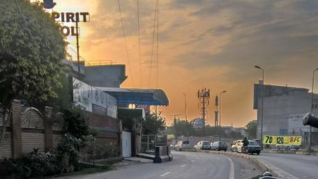 Serene City Sunset on a Quiet Road wallpaper