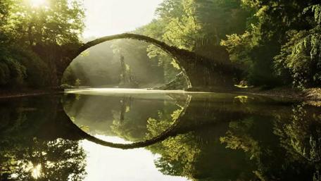 Mystical Stone Arch Over Still Waters wallpaper