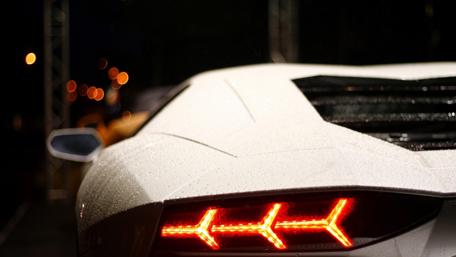 Sleek Sports Car Tail Lights at Night wallpaper
