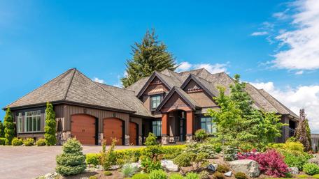 Stunning Mansion Surrounded by Vibrant Landscaping wallpaper