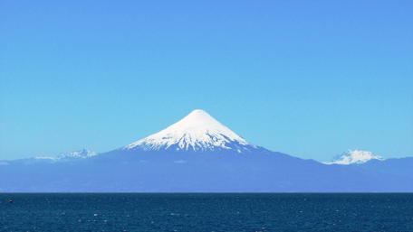 Majestic Snow-Capped Mountain Over Tranquil Waters wallpaper