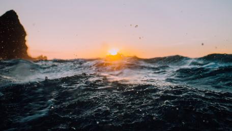Sunset Over Swirling Waves wallpaper